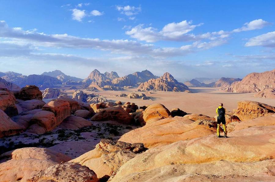 Hiker overlooking the Wadi Rum desert